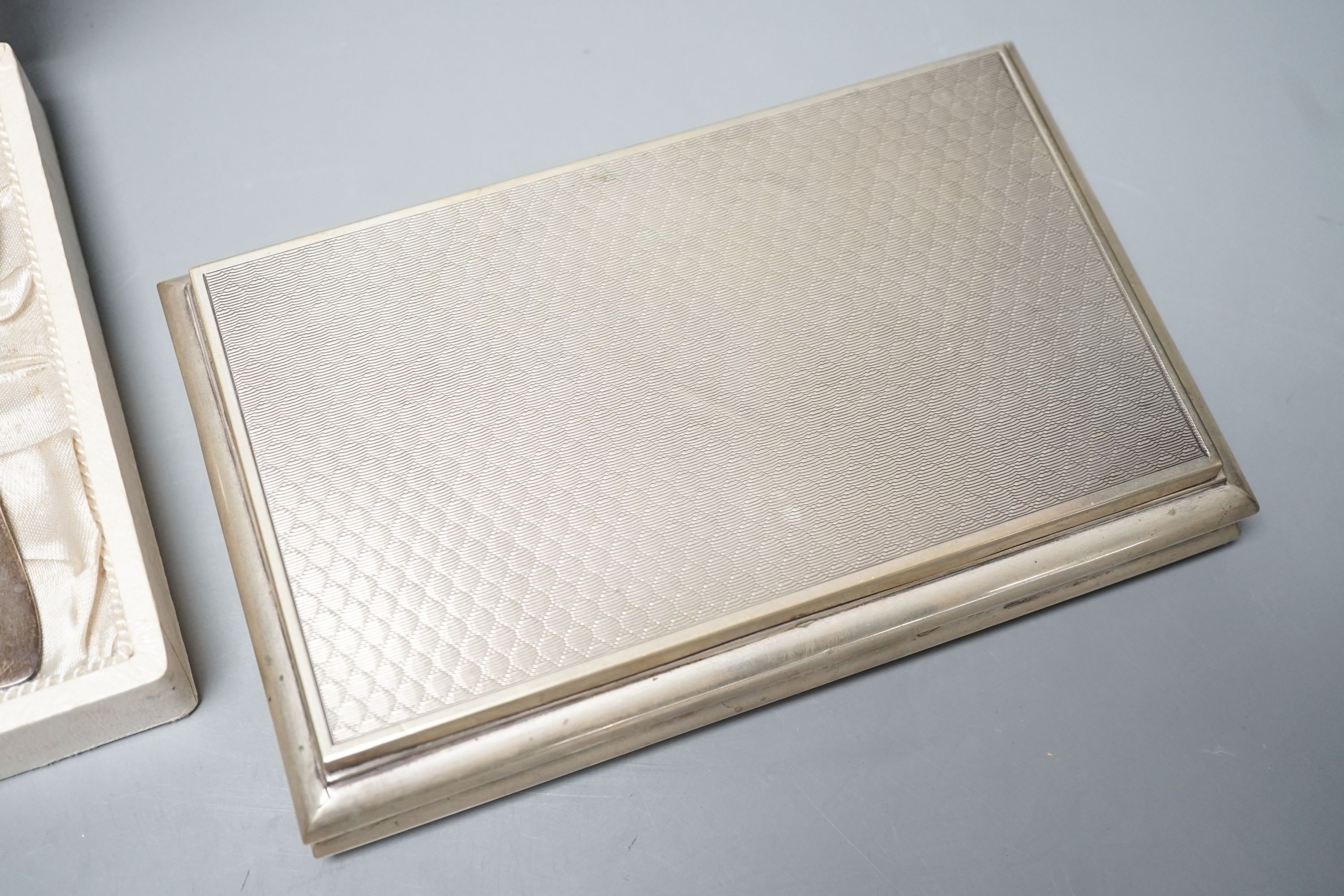 A modern Italian 800 standard white metal mounted cigarette box, 18.5cm and a cased French white metal egg cup and spoon.